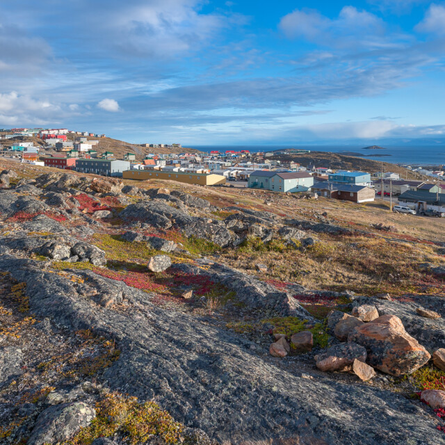 Overview of the city of Iqaluit with the Arctic Ocean harbor in the distance