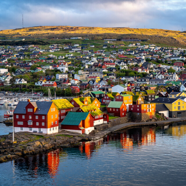 Sunrise scene of capital city Torshavn in Faroe Islands in North Atlantic. Urban scene of scandinavian city in warm golden sunlight.
