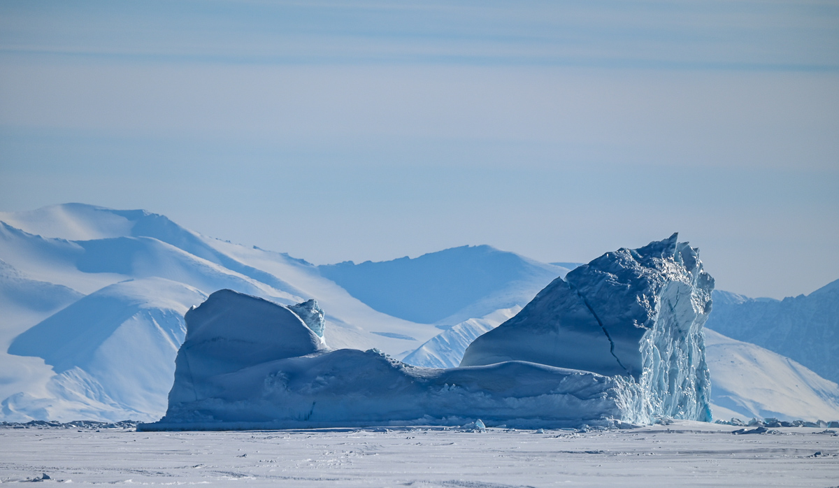 An iceberg surrounded by sea ice near Baffin Island