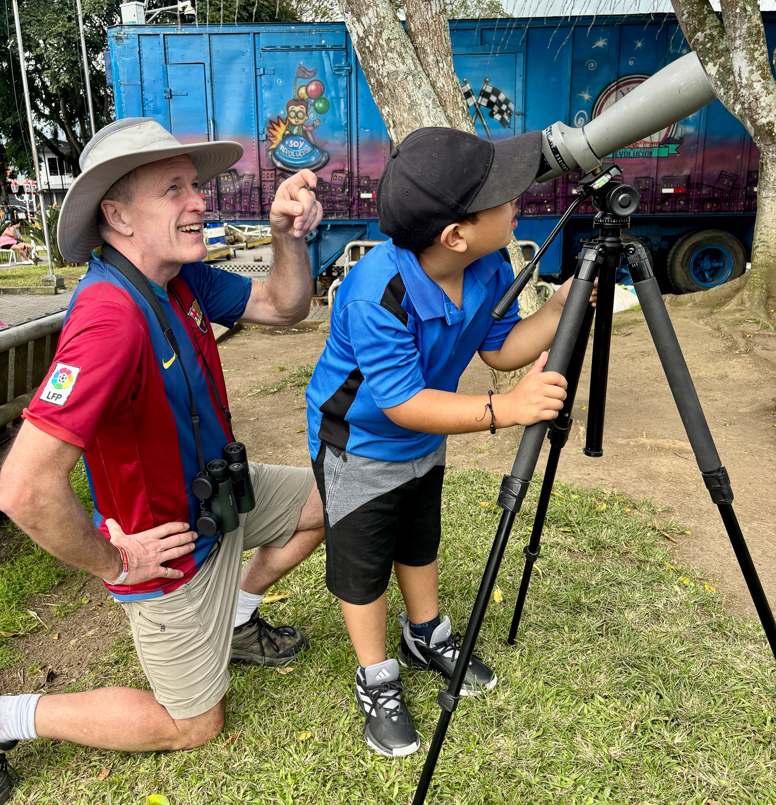guide showing child bird through spotting scope